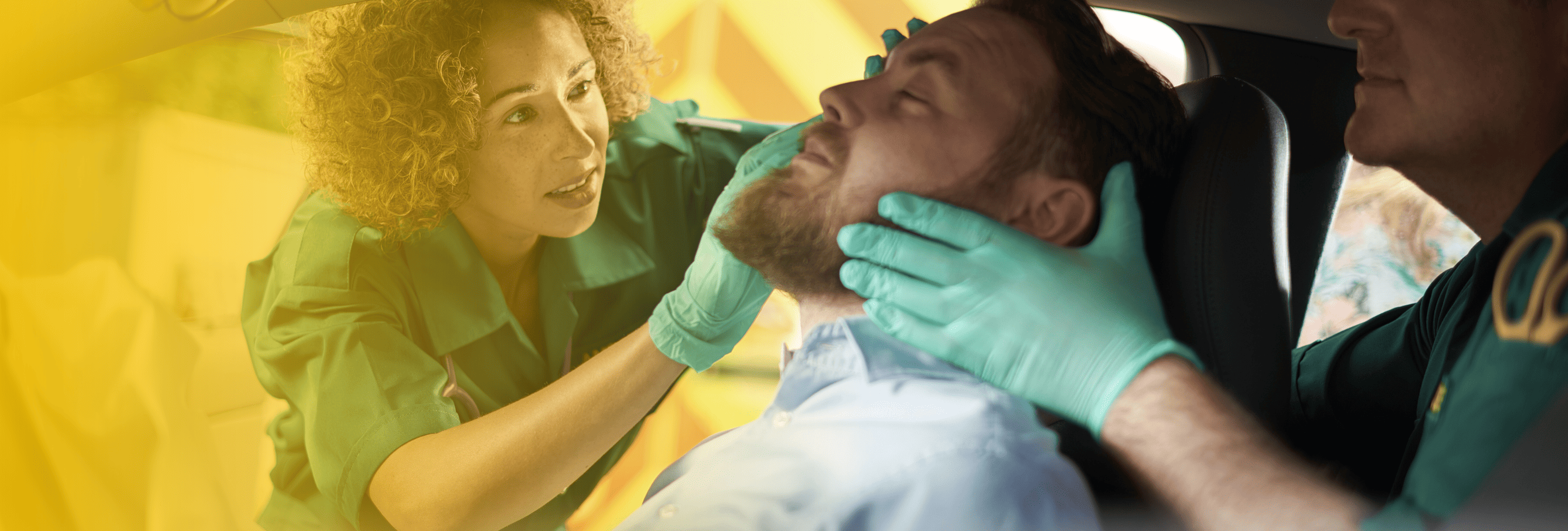 EMTs examining a man with potential neck/spinal injuries in car